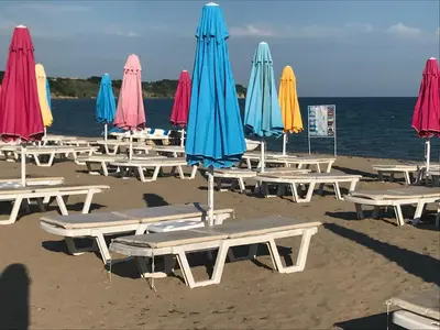 a group of tables and umbrellas on a beach at Sunrise Beach A4, Sarafovo in Burgas City