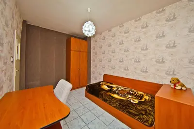 a bedroom with a bed and a wooden table at Perla 2-bdrm in the heart of the city in Varna City