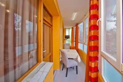 a small dining room with a table and yellow walls at Perla 2-bdrm in the heart of the city in Varna City