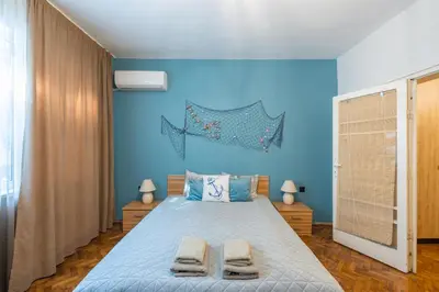 a blue bedroom with a bed with two towels on it at SeaBed Haven in Varna City