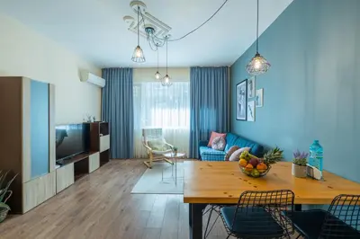 a living room with a table and a dining room at SeaBed Haven in Varna City