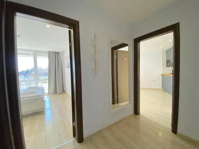 a room with two mirrors and a living room at Paradiso Aparthotel - Private apartment -BSR-2 in Nesebar
