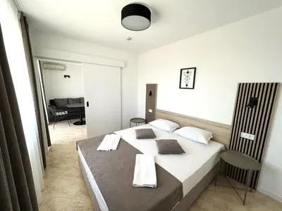 a bedroom with a large bed with towels on it at Villa Mia in Sozopol