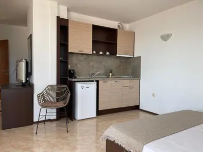 a kitchen with a sink and a white refrigerator at Villa Mia in Sozopol