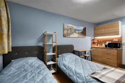 a small bedroom with a bed and a kitchen at Top Center, Sea Garden, Brand New Studio - Majestic in Burgas City