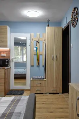 a room with wooden cabinets and a parrot on the wall at Top Center, Sea Garden, Brand New Studio - Majestic in Burgas City