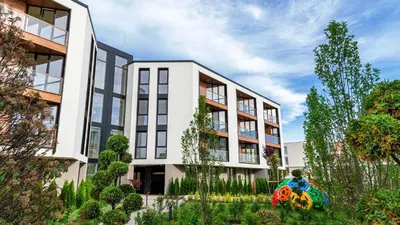 an apartment building with a garden in front of it at Casa Maiolica in Atlantis Atmosphere in Burgas City