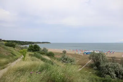 a group of people on a beach near the water at Casa Maiolica in Atlantis Atmosphere in Burgas City