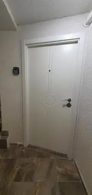 a white door in a room with a tile floor at Brand studio in Varna City