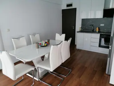 a white dining room table and white chairs in a kitchen at Sun Gates Byala in Byala