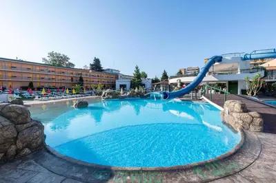 a large pool with a slide in a resort at Trakia Plaza Apartment in Sunny Beach