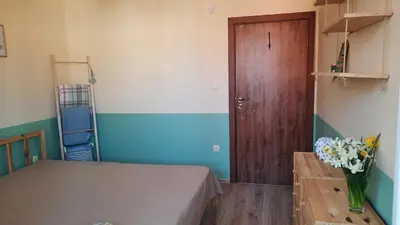 a bedroom with a bed and a wooden door at Soulful Apartments - AlmaLetta in Varna City