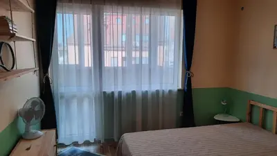 a bedroom with a bed and a window with curtains at Soulful Apartments - AlmaLetta in Varna City