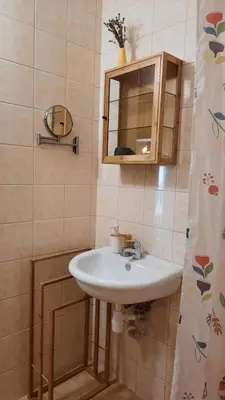 a bathroom with a sink and a mirror at Soulful Apartments - AlmaLetta in Varna City