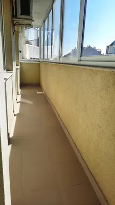 an empty hallway in an office building with windows at Soulful Apartments - AlmaLetta in Varna City