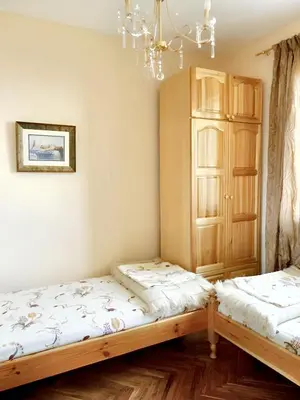 a room with two beds and a chandelier at Welcoming house in Varna with sea view in Varna City