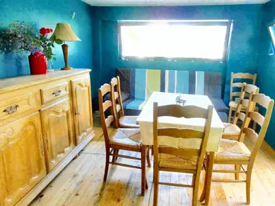 a dining room with a table and chairs and a window at Welcoming house in Varna with sea view in Varna City