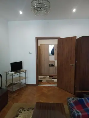 a living room with a sliding door and a television at 27 юли 3 бюджет in Varna City