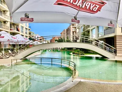 a bridge over a body of water with a river at Menada Casa del Sol Apartments in Sunny Beach