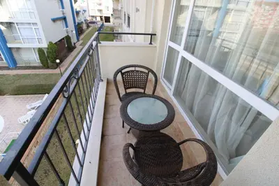 two chairs and a table on a balcony at Menada Casa del Sol Apartments in Sunny Beach