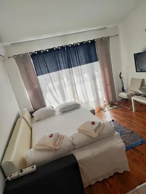 a bedroom with a large bed in front of a window at Art studio Marina Cape-private host in Ravda