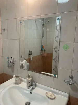 a bathroom with a sink and a shower with a mirror at Art studio Marina Cape-private host in Ravda