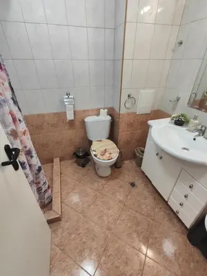 a bathroom with a toilet and a sink at Art studio Marina Cape-private host in Ravda