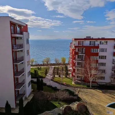 two apartment buildings with the ocean in the background at Apartament with See View in Sveti Vlas