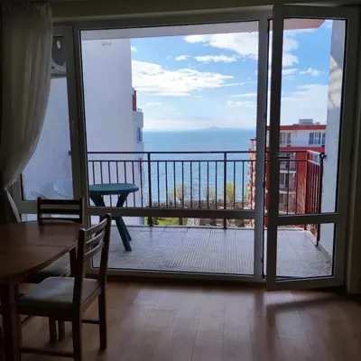 a room with a view of the ocean from a balcony at Apartament with See View in Sveti Vlas