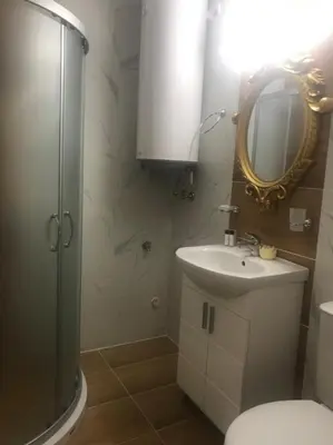 a bathroom with a toilet and a sink and a mirror at Sweet Homes 6 in Sunny Beach