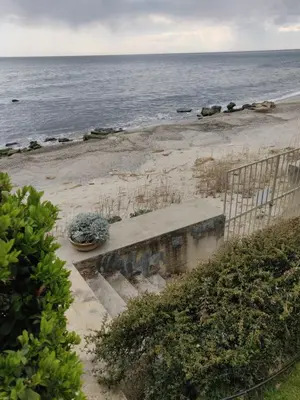 a stairway leading to a beach with a fence at Beach Villa Varna - cosiness 4 meters from the sea in Varna City