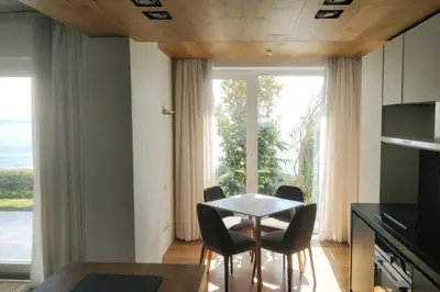 a kitchen and dining room with a table and chairs at Beach Villa Varna - cosiness 4 meters from the sea in Varna City