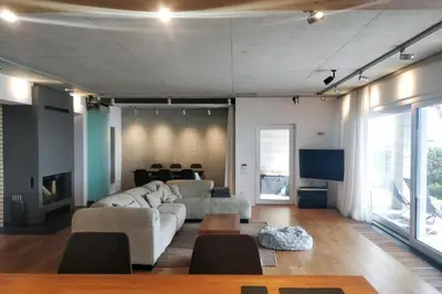 a living room with a couch and a tv at Beach Villa Varna - cosiness 4 meters from the sea in Varna City