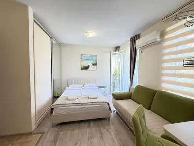 a living room with a bed and a couch at Marina Studio in Ravda
