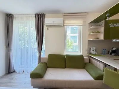 a living room with a couch in front of a window at Marina Studio in Ravda