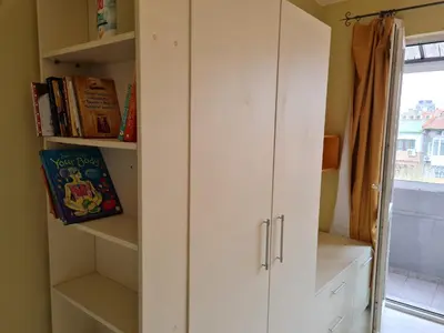 a room with a white cabinet with books at Spacious apartment 