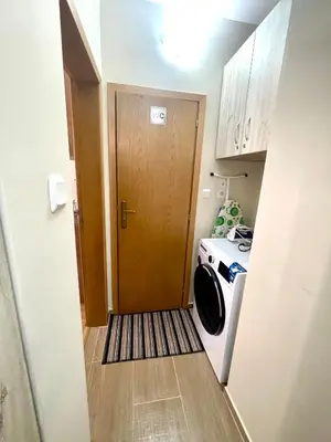 a door to a laundry room with a washing machine at Sunny in Varna City