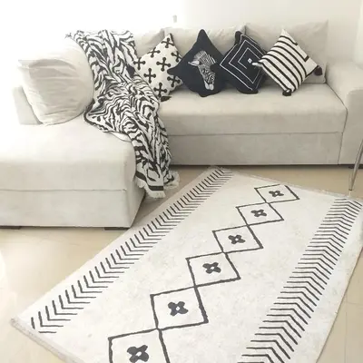 a living room with a white couch and a rug at Z&Z Apartment in Sozopol