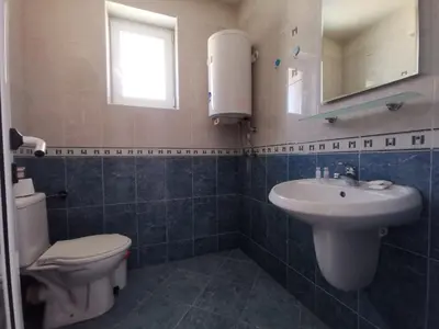 a bathroom with a white toilet and a sink at Z&Z Apartment in Sozopol