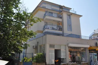 a tall white building with blue balconies at Z&Z Apartment in Sozopol