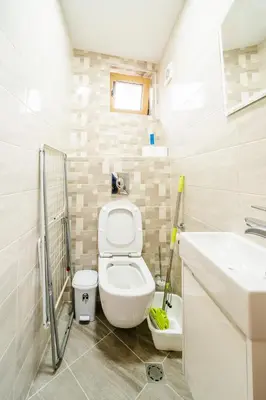 a small bathroom with a toilet and a sink at Апартамент за гости Веси in Burgas City