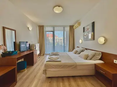 a bedroom with a large bed and a large window at Two bedroom apartment in Trakia Sunny Beach in Sunny Beach
