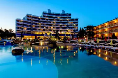 a hotel with a pool of water in front of a building at Two bedroom apartment in Trakia Sunny Beach in Sunny Beach
