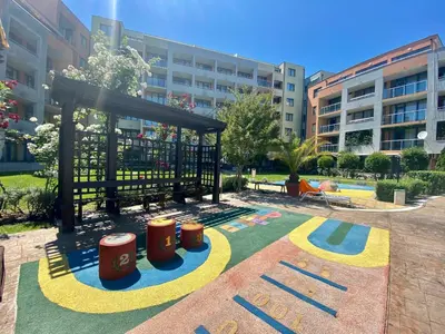 a playground in a park with a building in the background at Two bedroom apartment in Trakia Sunny Beach in Sunny Beach
