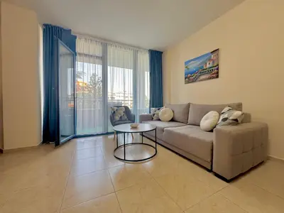 a living room with a couch and a table at Two bedroom apartment in Trakia Sunny Beach in Sunny Beach