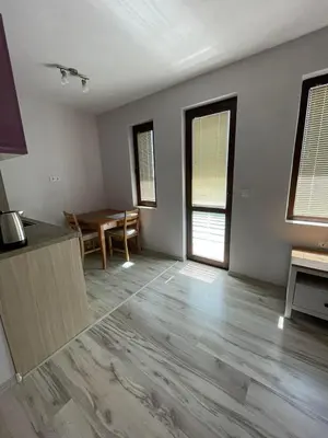 a living room with a table and a dining room at Къща за гости “Недев” in Tsarevo