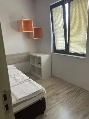 a small room with a bed and a window at Къща за гости “Недев” in Tsarevo