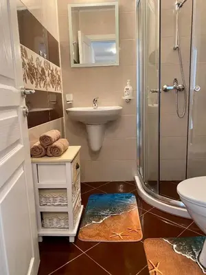 a bathroom with a shower and a sink and a toilet at Apartman Kuba in Primorsko
