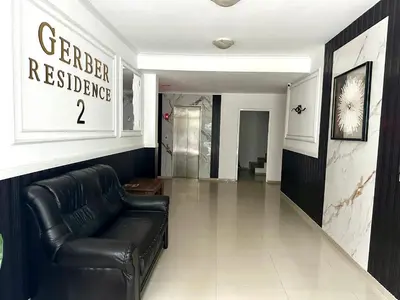 a living room with a leather couch in a lobby at Gerber Residence 2 in Sunny Beach