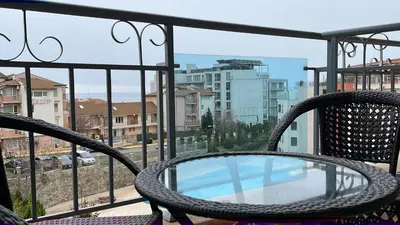 a balcony with a table and chairs on a balcony at Sun Wave Apartment Presige in Sveti Vlas